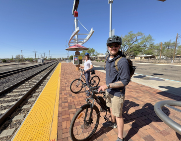 Picture of two people with bicycles waiting to board the Rail Runner Train at Downtown Bernalillo