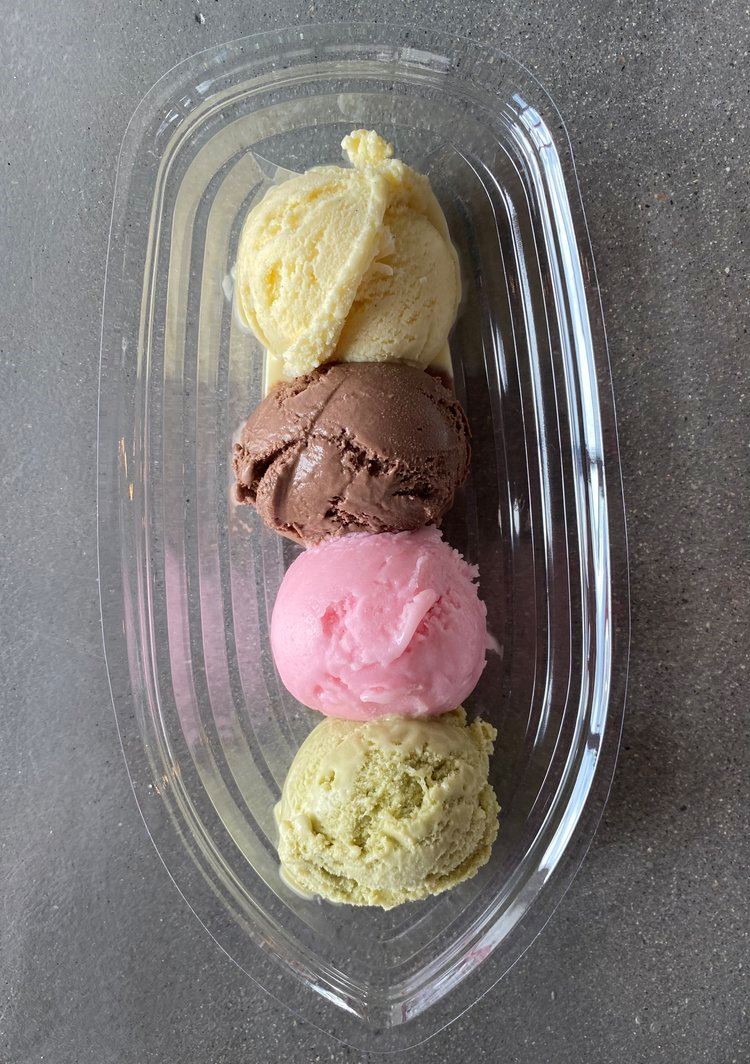 Four scoops of ice cream in a clear dish