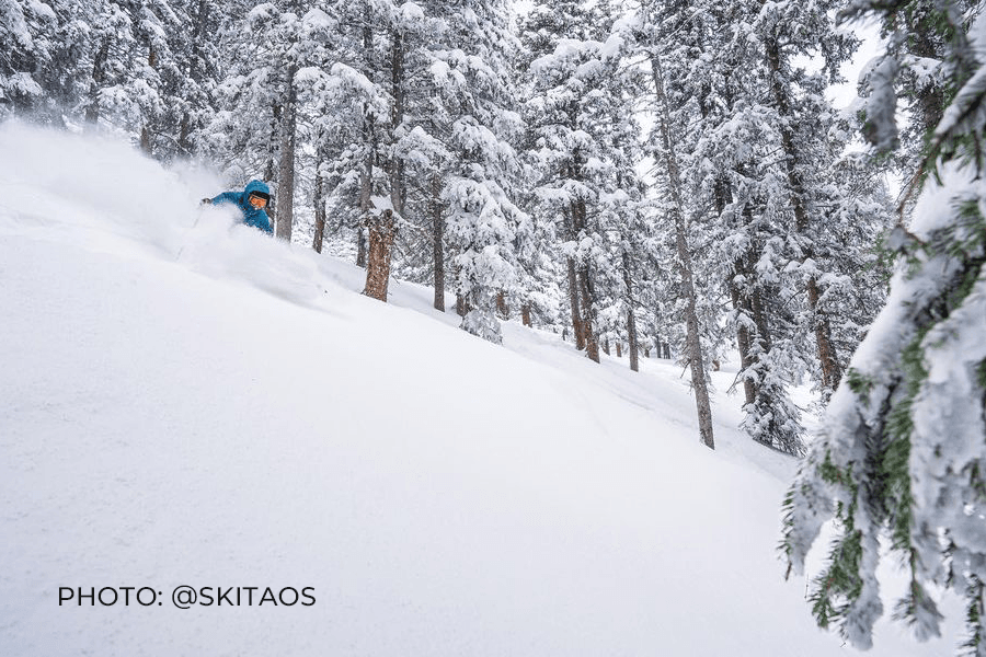 Picture of a person skiing on a very snowy mountain in Taos New Mexico