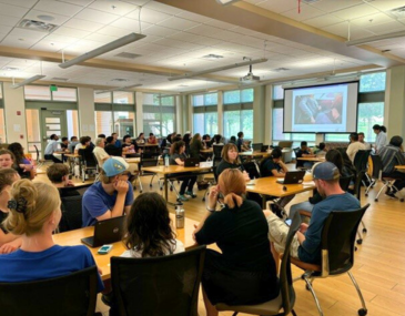 Large group of students attending a workshop in a classroom setting