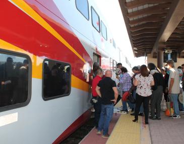 Close up picture of people boarding the Rail Runner train
