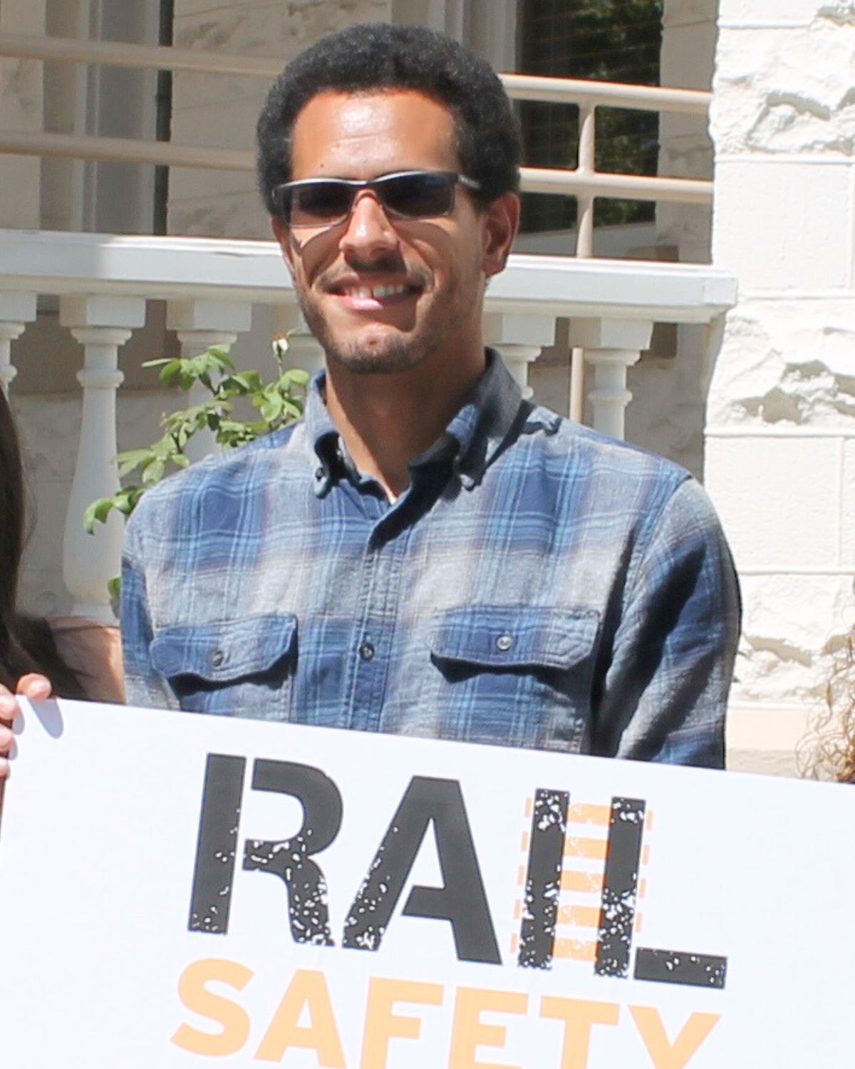 Rio Metro employee Eric Murphy holding a sign that says Rail Safety
