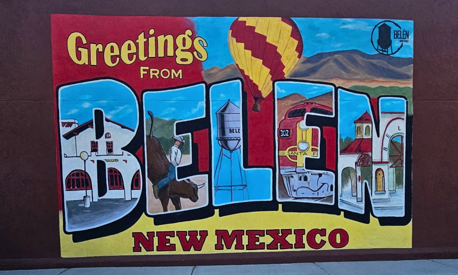 Picture of a mural on the side of a building that looks like a post card for Belen New Mexico