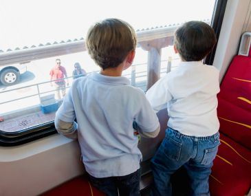 Young Kids Looking out Rail Runner Train Window