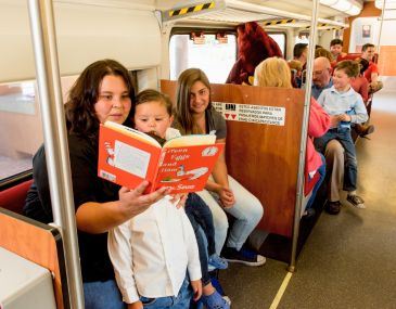 Child Reading a Book on the Rail Runner Train